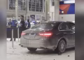 Car crashes into ticket counter at Detroit Metro Airport, six treated; driver in custody.
